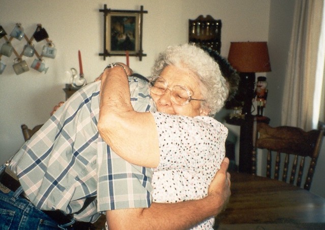 Elderly woman and man hugging