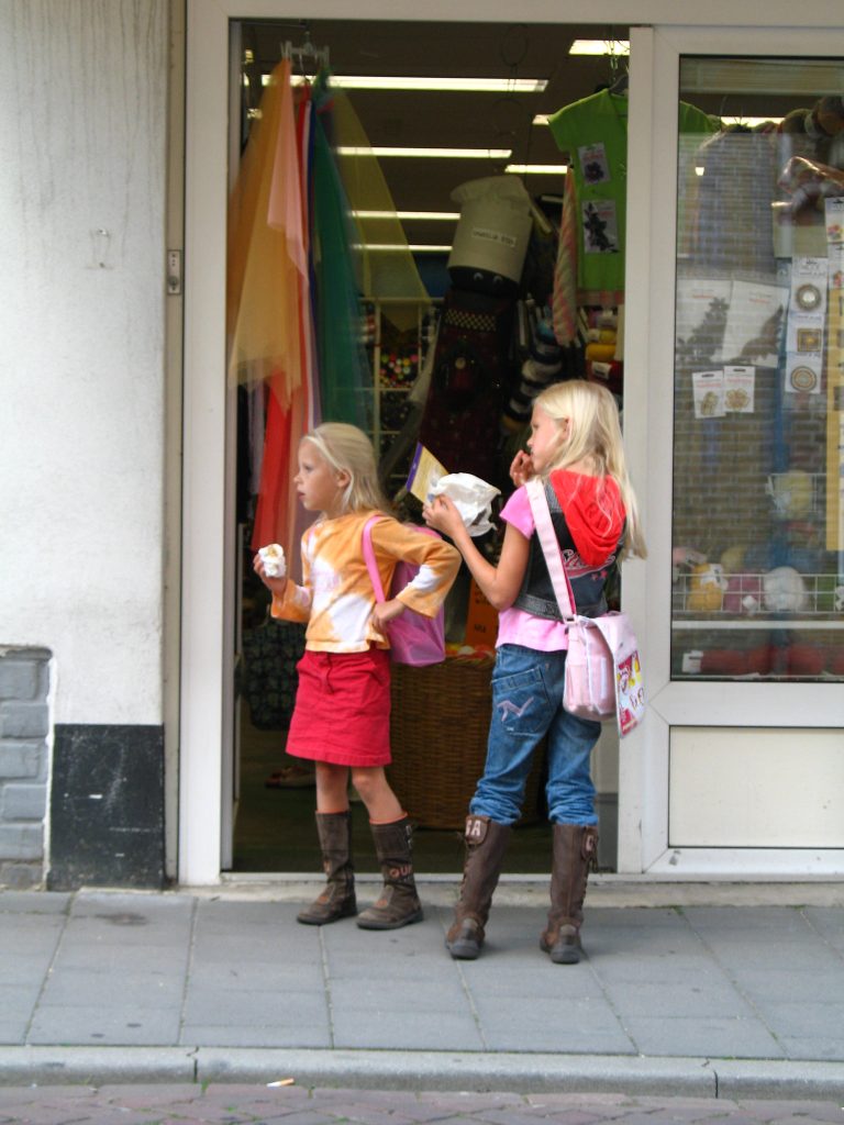 Kids standing outside of a store with snacks