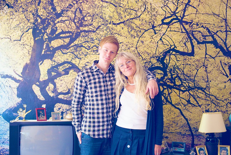 Grandma and grandson posing in front of wallpaper