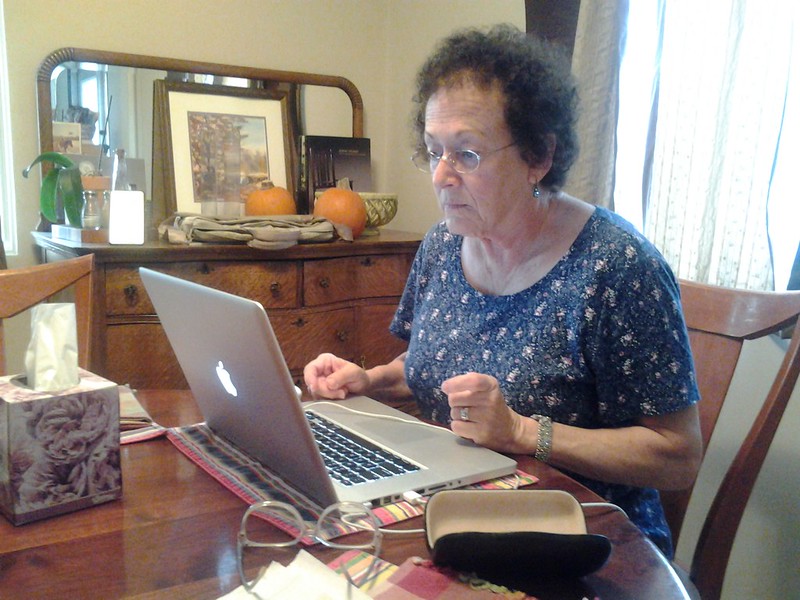 Grandma uses her MacBook laptop to check her email