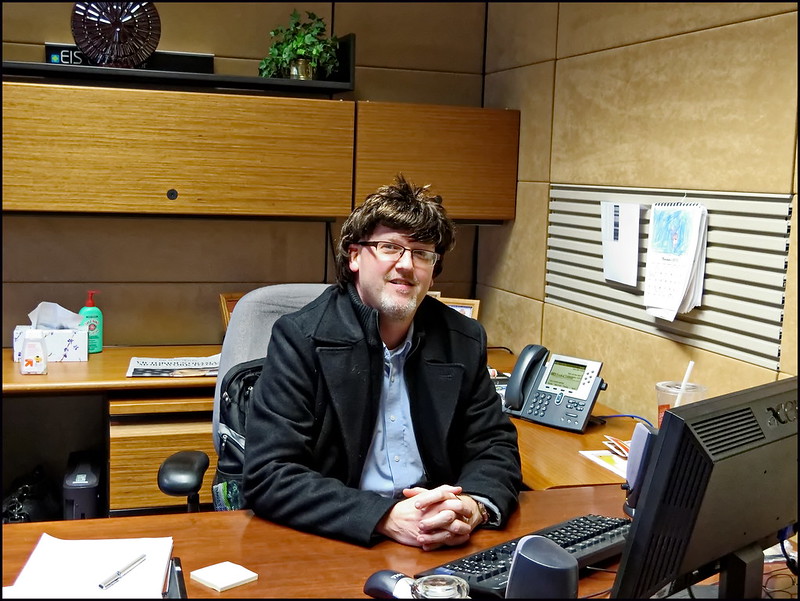 Boss in wig disguise at desk
