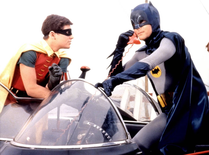 Actors Burt Ward and Adam West are seen here using a Batphone inside of the Batmobile in the 1966 film