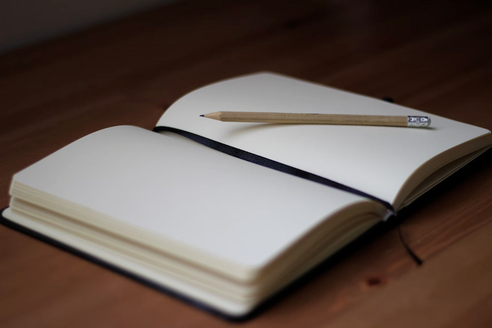 A notebook with a pencil