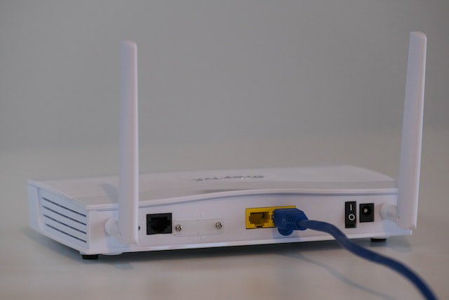 Broadband internet router with ethernet cable plugged in to the back in the ethernet port