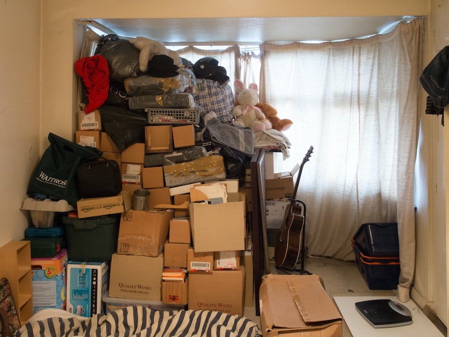 Brown cardboard boxes and other things stored in an extra room