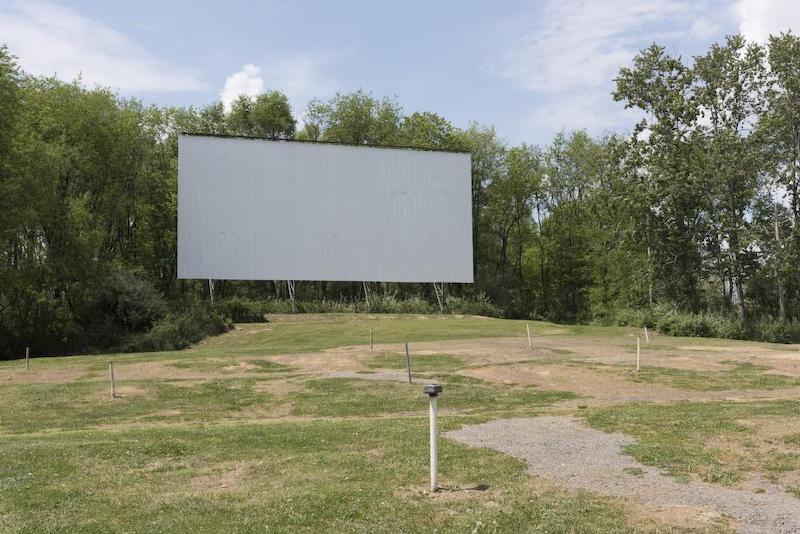 The screen and sound poles (minus their audio boxes) at the Hilltop Drive-In Theater in Chester, West Virginia, which was once one of 75 active drive-in movie theaters in the state