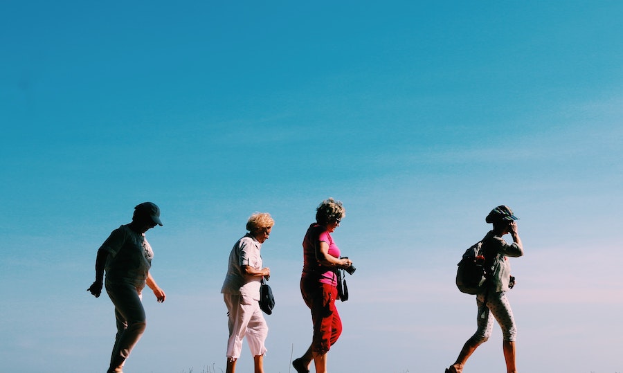 Four women walking on a nice day
